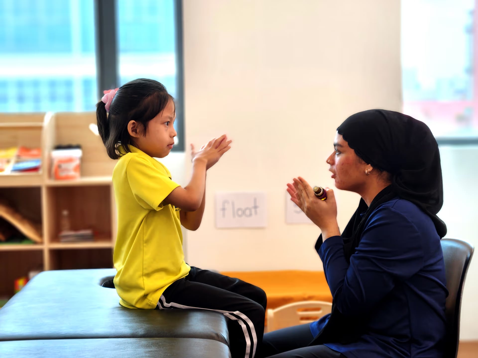 teacher helping special needs children of MIJ Hub